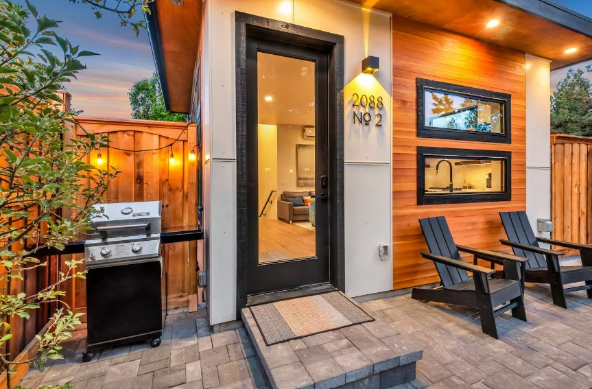 ADU entry with glass door and cedar siding