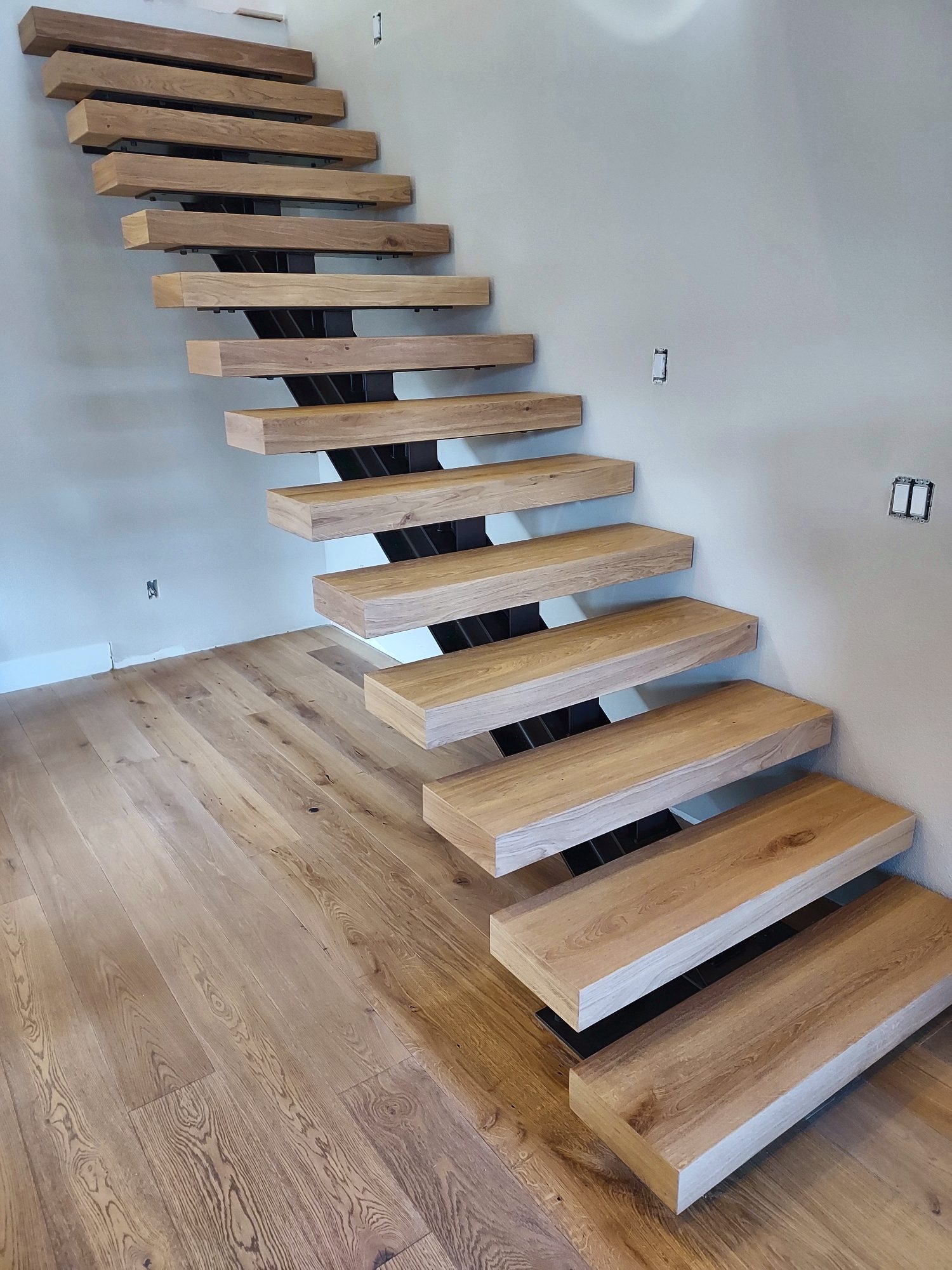 Floating white oak stair on a steel stringer
